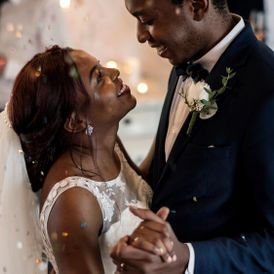 A newly wed couple having their first dance.